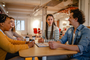 multicultural work team have meeting research together on work desk