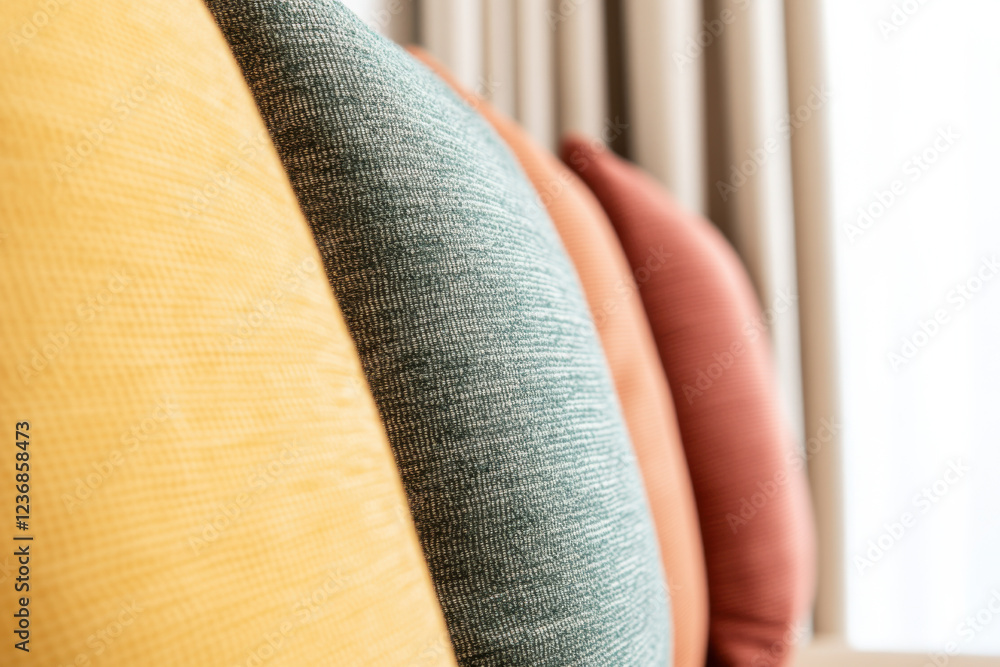 Poster a row of pillows with different colors and textures