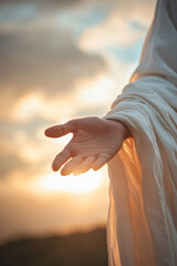 Jesus reaching out his hand against dark background Resurrected Jesus Christ reaching out hand and praying