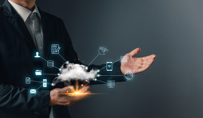 A hand holds a cloud computing icon, symbol data storage, secure backup, and management for uploading, downloading, and transfer files in a connected digital network and internet service environment.