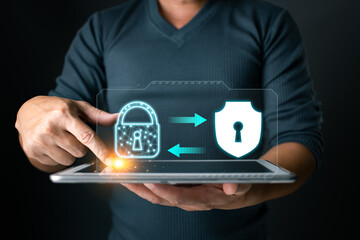 Secured connection. A user interacts with a tablet displaying a lock and shield, symbolizing secure...