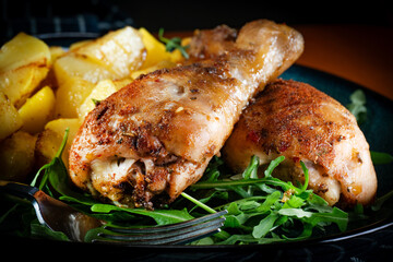 Baked chicken drumsticks with potatoes.