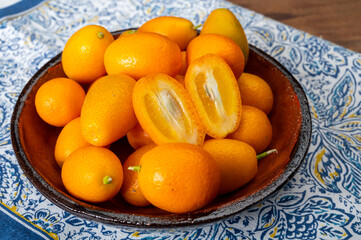 Delicious small citrus fruits orange kumquats close up