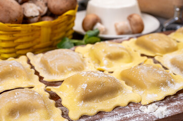 Italian food, fresh home made stuffed pasta ravioli dumplings with ricotta soft cheese and champignons porcini mushrooms, Parma, Emilia Romagna, Italy