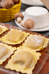 Italian food, fresh home made stuffed pasta ravioli dumplings with ricotta soft cheese and champignons porcini mushrooms, Parma, Emilia Romagna, Italy