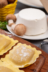 Italian food, fresh home made stuffed pasta ravioli dumplings with ricotta soft cheese and champignons porcini mushrooms, Parma, Emilia Romagna, Italy