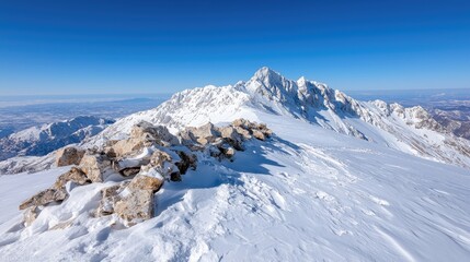 Snow-capped mountain peak panorama, clear sky, winter landscape, travel