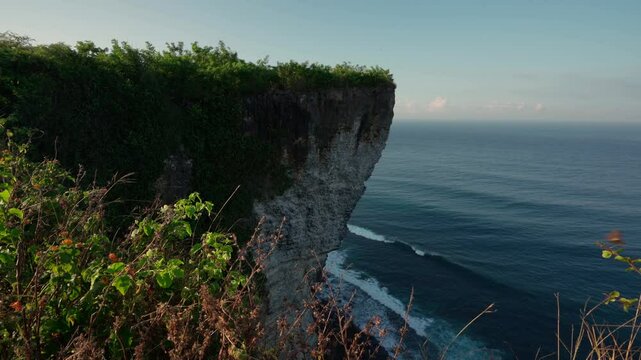Karang Boma Cliff Bali on background ocean waves crashing on the tropical beach Bali Indonesia 4K