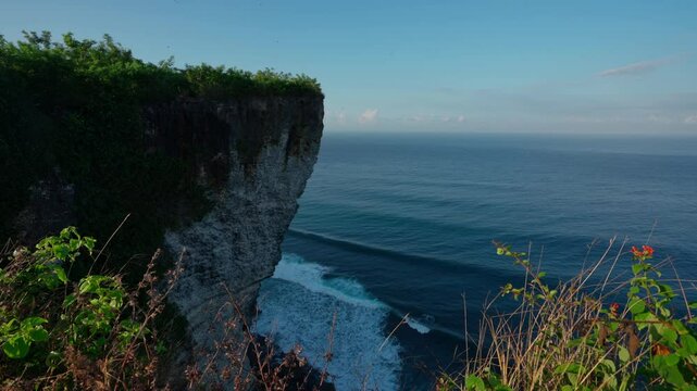 Karang Boma Cliff Bali on background ocean waves crashing on the tropical beach Bali Indonesia 4K