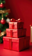 Obraz premium Stack of red Christmas gift boxes on a surface, table, christmas, red