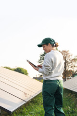 Female farmer with digital tablet on a modern farm using solar panels