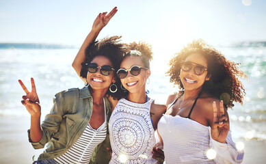Friends, holiday and women with peace sign by beach for fun vacation, travel adventure and bonding together. Sunglasses, people and happy with hand gesture for summer trip, seaside support and relax