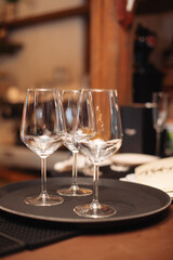 Two empty, beautiful, clean glasses are on a tray in the restaurant.