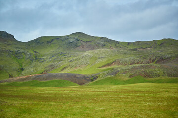 Beautiful nature landscape with green fields and majestic cliffs with ice and snow in Southern...