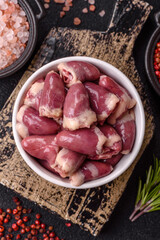 Raw chicken hearts with salt, spices and herbs