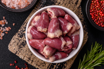 Raw chicken hearts with salt, spices and herbs
