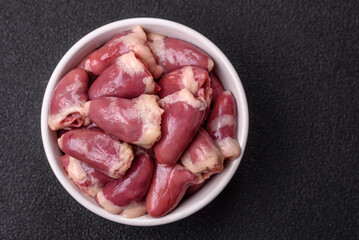 Raw chicken hearts with salt, spices and herbs