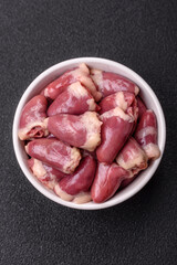 Raw chicken hearts with salt, spices and herbs