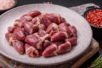 Raw chicken hearts with salt, spices and herbs