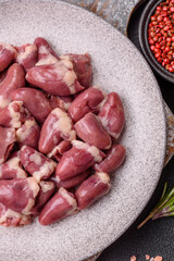 Raw chicken hearts with salt, spices and herbs