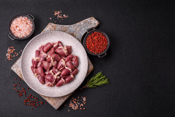 Raw chicken hearts with salt, spices and herbs