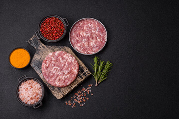 Fresh raw ground beef or pork burger patty with salt and spices