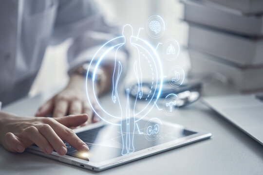 The doctor uses modern technologies, a virtual screen with a hologram. The concept of medicine of the future.