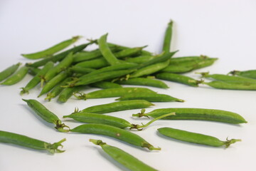 A bunch of fresh green pea pods, showcasing vibrant, organic produce