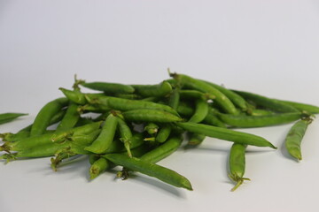 A bunch of fresh green pea pods, showcasing vibrant, organic produce