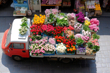 Colorful flower truck with diverse blooms at market stalls on cobblestone street