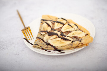Tasty pancakes with sliced banana served on white table
