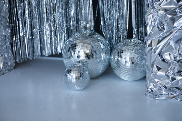 Disco ball on a blue background with shadows and highlights of bright sunlight. Abstract holiday background.