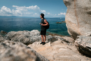 Man Gazing at the Sea from Rocky Shore
