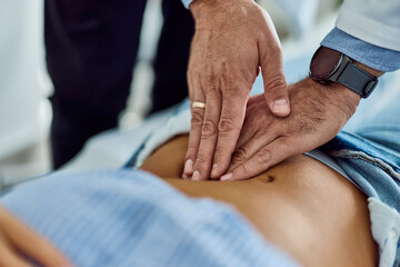 Doctor Conducting Abdominal Examination During a Medical Checkup in a Clinical Setting