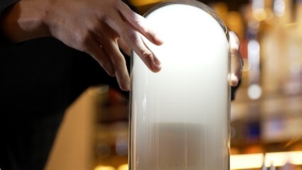 Focusing cropped hand bartender serving mist smoky Old fashioned in whiskey cocktail presentation for recommending special welcome tasty creative advertisement drink at beverage counter bar. Vinosity.