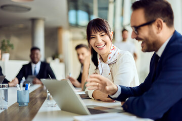 Team Collaboration in Modern Office, Professionals Sharing Ideas and Laptop Discussions