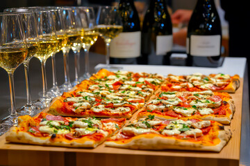 Upscale pizza tasting event with wine pairings. 