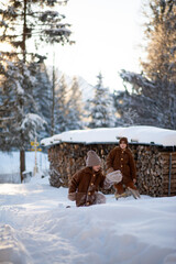 Little girls enjoy sledding. Children's sled. The kid is sledding. Children play outside in the snow. Children sledding in the Alps in winter. Outdoor fun for family Christmas holidays.