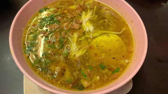 Soto Ayam (chicken soup) with rice noodles, Indonesian food in a bowl.