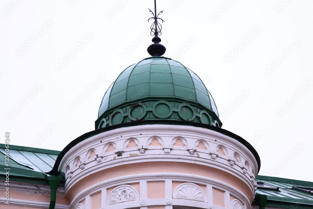 Poster a tall building with a large clock on its roof.