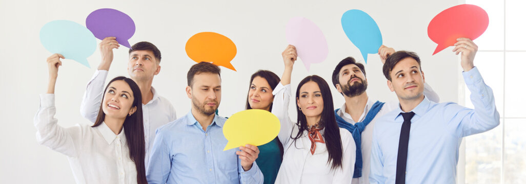 Diverse group of business people holding bright color empty paper speech bubble, representing talk, chain thought bubble thinking dialogue balloon, free idea suggestion, plan, sharing opinion, belief