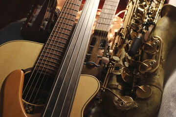 A striking image of various musical instruments, where the sleek curves of a saxophone meet the structured lines of guitar fretboards