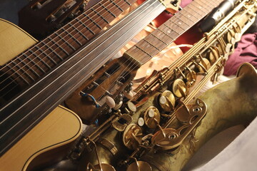 A striking image of various musical instruments, where the sleek curves of a saxophone meet the structured lines of guitar fretboards