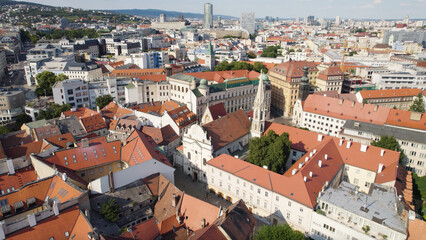 Bratislava's red-roofed buildings with church of the annunciation on a sunny day, aerial view