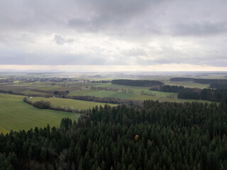 Black Forest in autumn with a view over the trees into the valley, drone photo
