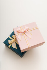 Two celebrated gift boxes lie on white background