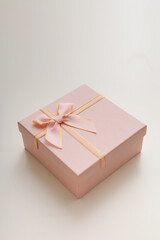 Pink celebrated gift box lie on white background