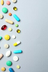 Various pills on gray background