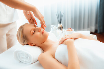 Caucasian woman enjoying relaxing anti-stress head massage and pampering facial beauty skin...