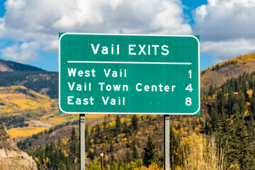 Vail exit signpost on road highway in Colorado towns in rocky mountains with sign on street scenic views of fall autumn foliage